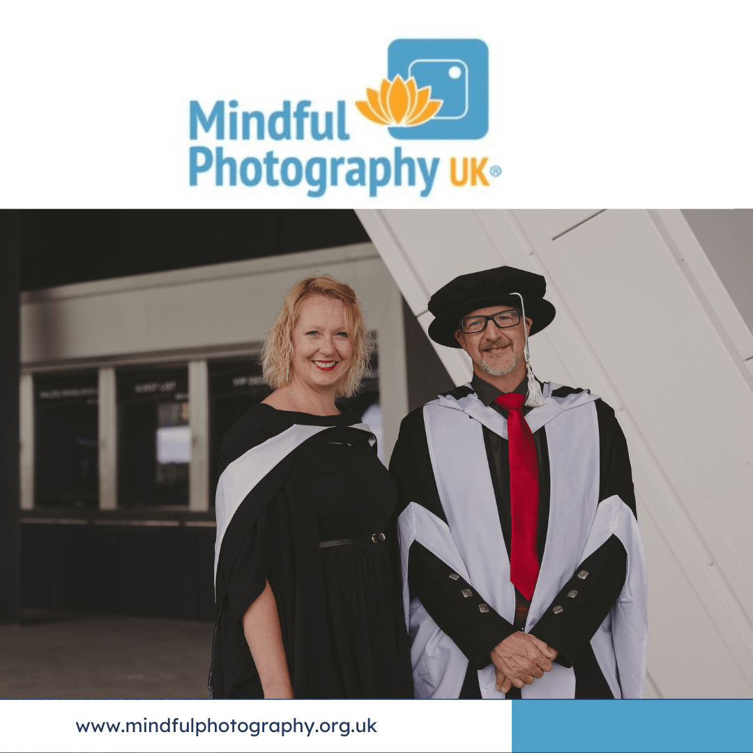 A mature female student at graduation and male academic in robes